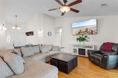 Living area with vaulted ceiling, a chandelier, ce
