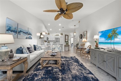 Living room featuring light colored LVP flooring, high vaulted ceiling, ceiling fan, and recessed lighting