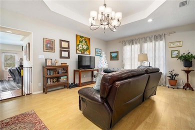 Living area with an inviting chandelier, light woo
