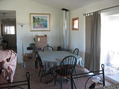 Dining area off kitchen with living room to left.