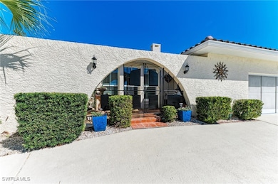 View of exterior entry featuring stucco siding and