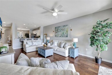 Living room with ceiling fan and dark hardwood flo