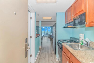 Kitchen featuring stainless steel fridge, sink, el