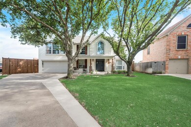 View of front facade with a garage and a front lawn