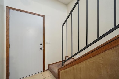 Entryway featuring light tile patterned floors and