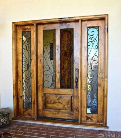 Gorgeous front door with beautiful iron scroll wor