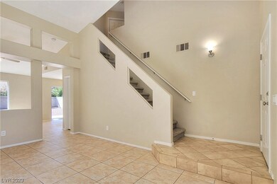 Living Room with Vaulted Ceiling and Tile Flooring