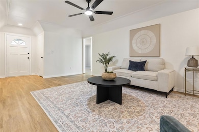 Living area with light wood-style floors, recessed lighting, and a ceiling fan