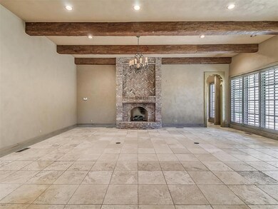 Living room with beamed ceiling, light tile floori