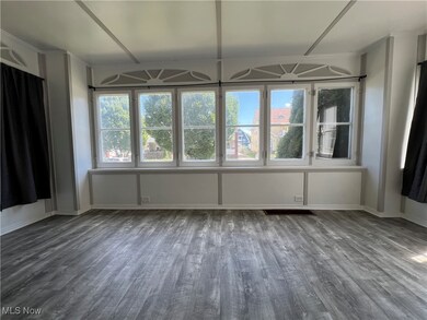 Spare room with dark hardwood / wood-style flooring