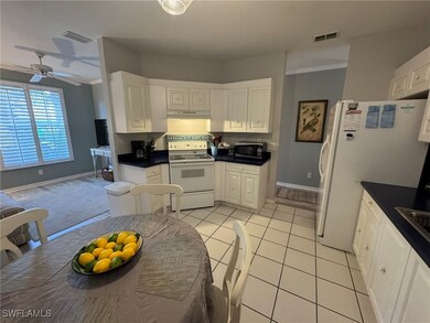 Kitchen featuring ornamental molding, white cabine