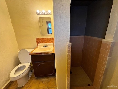 Bathroom with tile patterned flooring, vanity, and toilet