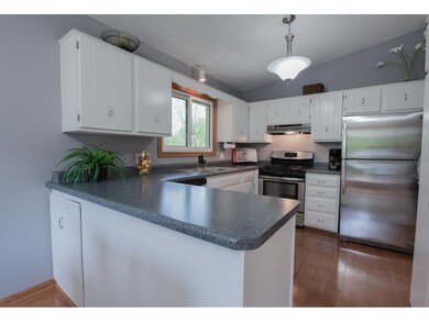 The light and bright kitchen boasts stainless stee