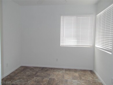 Empty room with stone finish flooring and baseboar