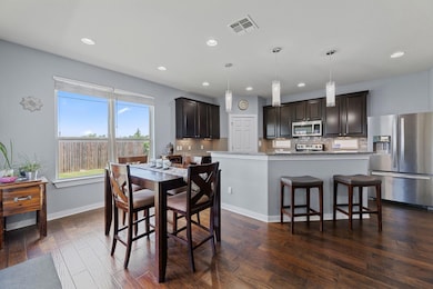 Dining area featuring recessed lighting and dark 
