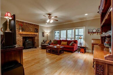 With a brick fireplace that has a wood burning sto