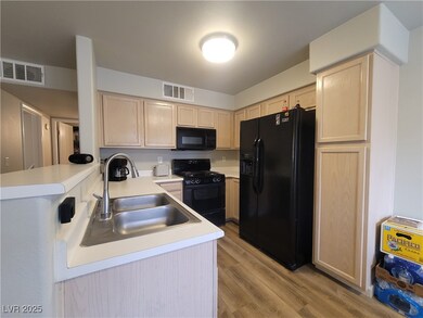 Kitchen featuring visible vents, light wood-style