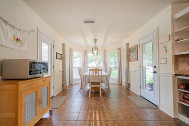 Dining area with a textured ceiling and dark tile 