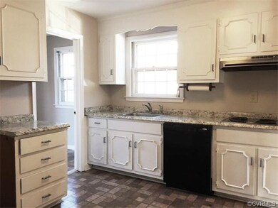 Kitchen with access to utility room and door to back yard