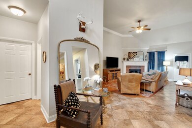 Living room featuring ornamental molding, a brick 