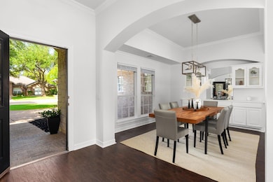 Dining room featuring wood finished floors, arche
