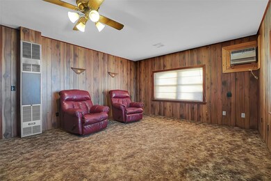 Living room featuring ceiling fan, a wall mounted 