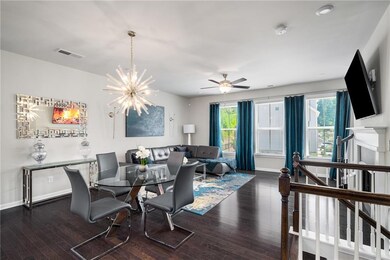 Dining room with hardwood / wood-style flooring, a chandelier, and a ceiling fan