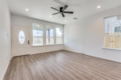Foyer entrance featuring ceiling fan and light har