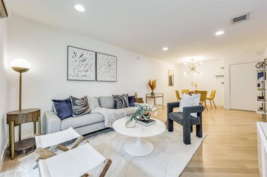 Living room featuring light hardwood / wood-style floors and an inviting chandelier