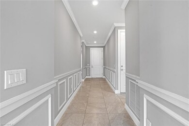 Hallway featuring visible vents, recessed lighting