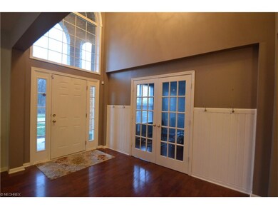 Beautiful two story foyer entry with rich hardwood