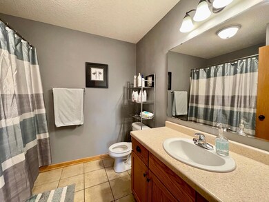Main floor full bathroom is situated across from the third bedroom and near the living room and dining area.