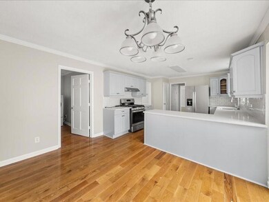 Kitchen with an inviting chandelier, a sink, light