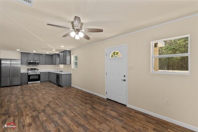 Kitchen with gray cabinetry, dark hardwood / wood-