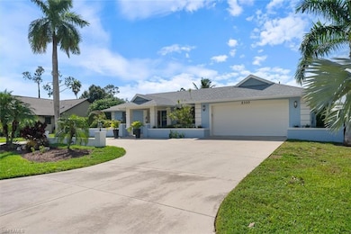 Ranch-style home with a front yard and a garage