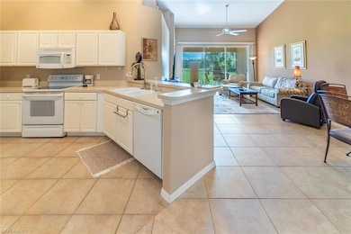 Kitchen with light tile patterned flooring, white 