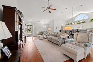 Living room featuring high vaulted ceiling, ceilin