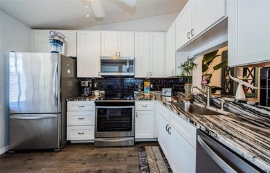 Luxury vinyl tile in kitchen and has a pass through to dining/living room