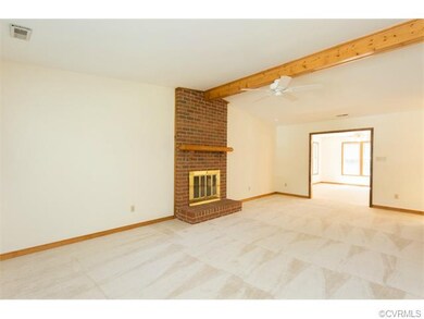 Living Room with brick fireplace and ceiling fan. 