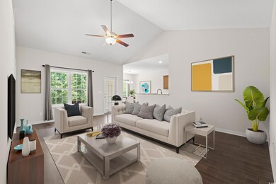 Living room with ceiling fan and high vaulted ceil