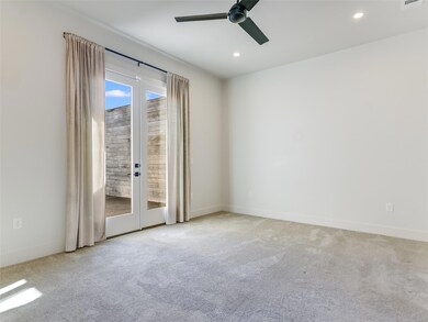 Empty room with carpet flooring, ceiling fan, fre