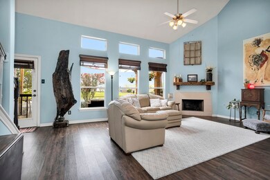 Wall of windows in living room over-looking relaxing patio and private neighborhood lake
