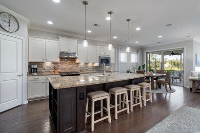 Kitchen featuring white cabinetry, dark hardwood /