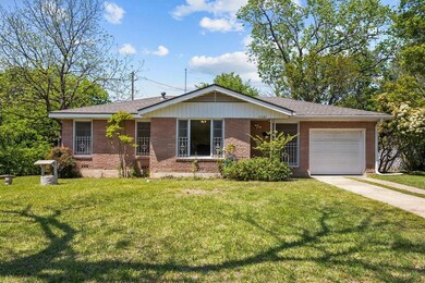 Ranch-style house with concrete driveway, roof wit