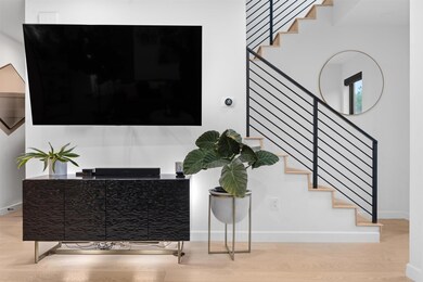 Staircase featuring wood finished floors and base