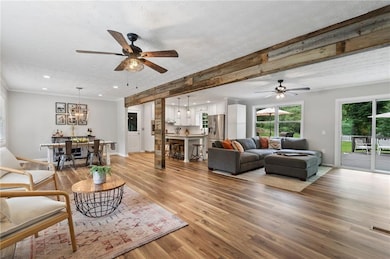 Beamed ceiling, hardwood floors in this open floorplan.
