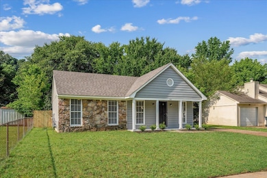 View of front of house featuring stone siding, a porch, roof with shingles, and a garage