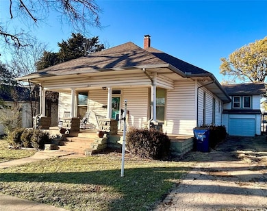 Bungalow with covered porch, roof with shingles, a