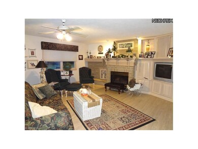Large living room with wood flooring, bricked gas 
