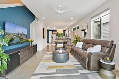 Living room with recessed lighting, concrete floo